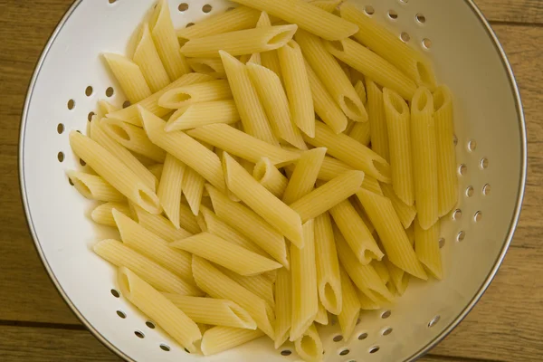 stock image Pasta in colander on table