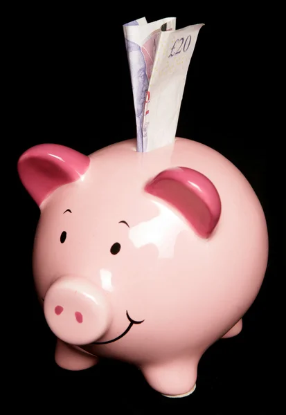 Piggy bank met twintig pond nota — Stockfoto