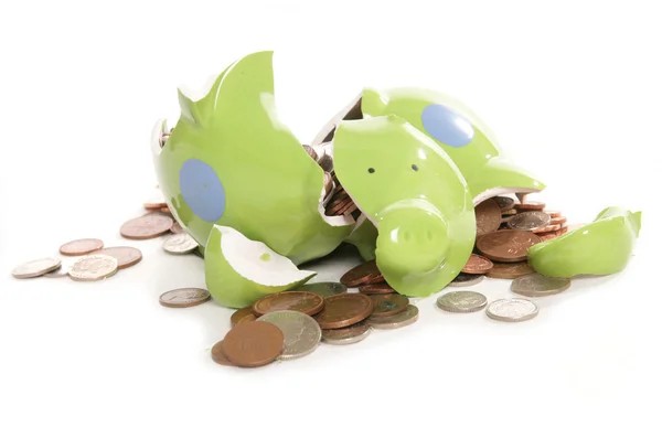 Smashed piggy bank moneybox with British currency coins — Stock Photo, Image