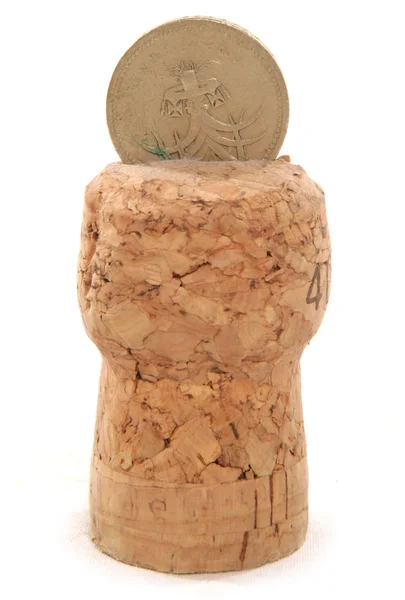 Champagne cork with pound coin cutout — Stock Photo, Image
