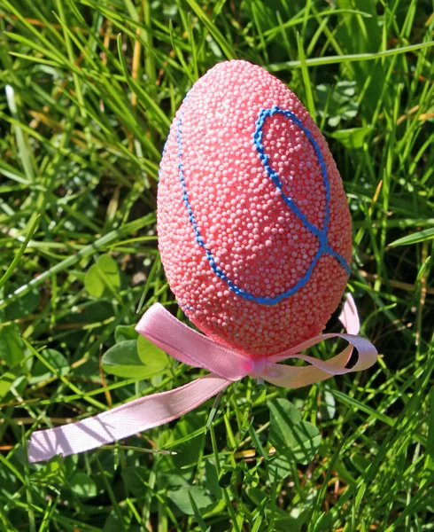 Ovos de Páscoa rosa em um gramado verde — Fotografia de Stock