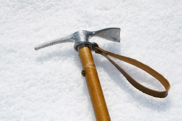 Ax hook firmly fixed in a wall of ice in high mountains — Stock Photo, Image