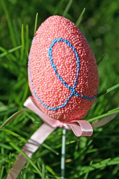 stock image Pink Easter eggs in a green lawn