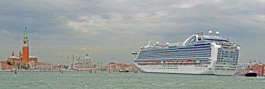 Huge cruise ship arrives at the port of Venice with tourists clipart