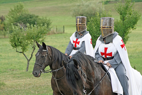 Two medieval crusaders shall strutting with their horses blacks in the Ital