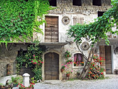 Old house in a courtyard of a mountain village clipart