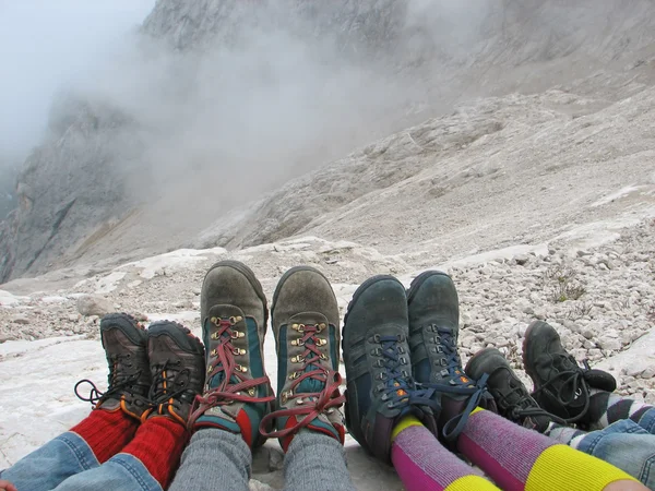 Hiking boots of a family rest on the Italian Alps — Stock Photo, Image