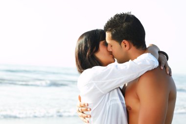 Adorable couple in love kissing and embracing each other clipart