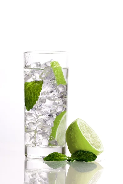 stock image Composition of one mojito, one lime and a mint leaf.