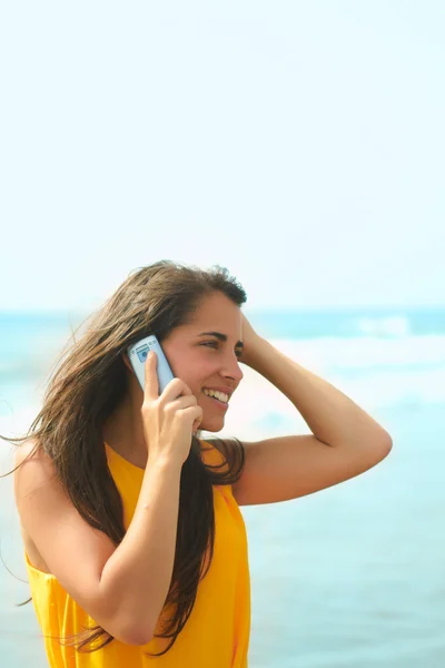 stock image Smiling young lady talking on a cellphone