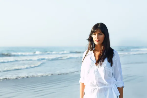 stock image Girl walking along the seashore