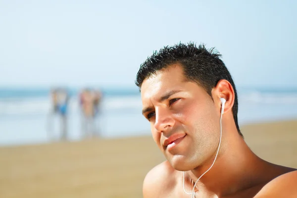 stock image Guy on the beach listening to music