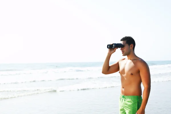 stock image Boy with binoculars looking at the seashore