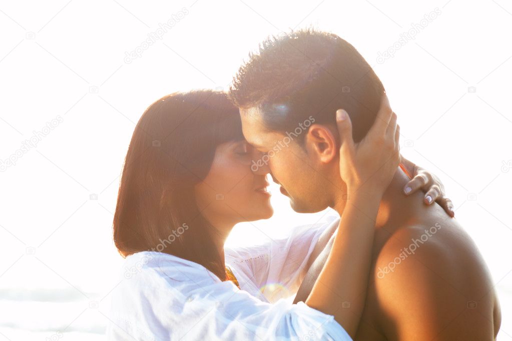 Passionate couple in love kissing and embracing between backli