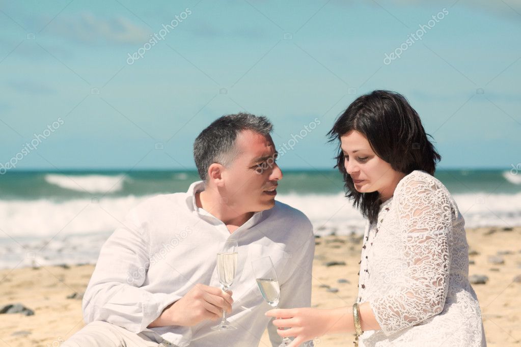Couples talking with glasses in hand