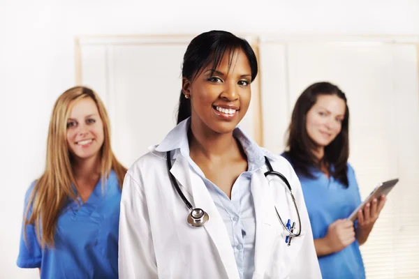 Doctor standing in front of his team Stock Photo