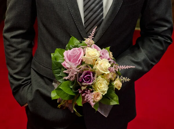 Wedding bouquet in hands of the groom — Stock Photo, Image