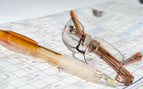 Das Foto des Kreuzworträtsels, die Brille, der Stift — Stockfoto