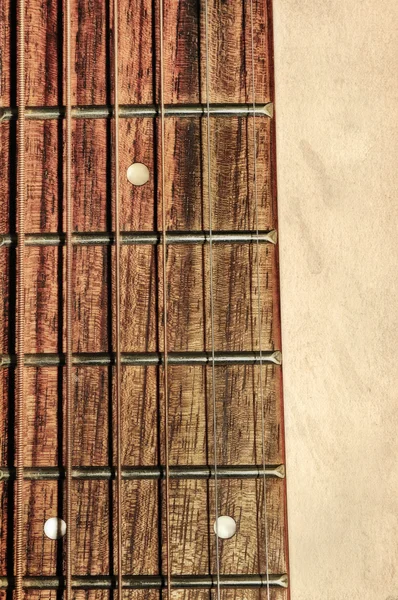Guitarra pescoço fingerboard no fundo texturizado — Fotografia de Stock