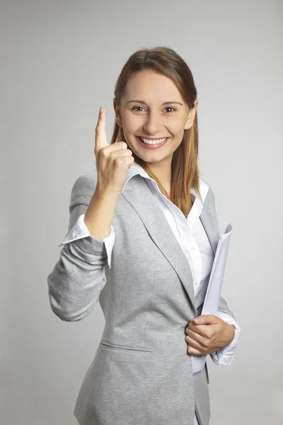 Woman showing ONE sing and smiling — Stock Photo, Image