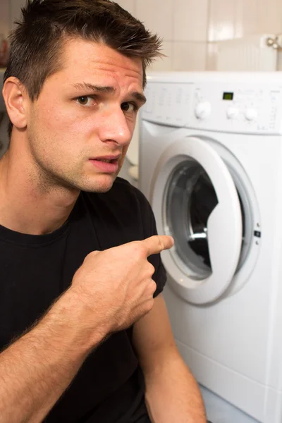 stock image Young man unhappy with washing mashine