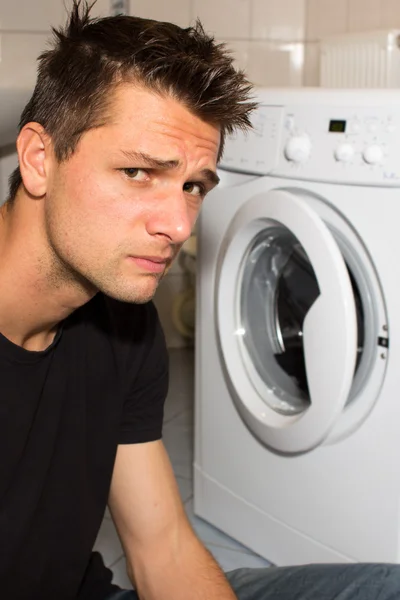 stock image Young man unhappy with washing mashine