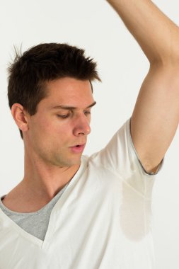 Man sweating very badly under armpit and pointing there clipart