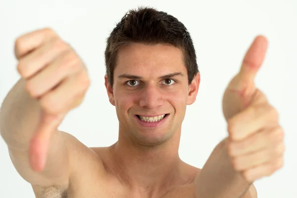 Fiatal attrective férfi csinál a hüvelykujjával felfelé és más hüvelykujj-le — Stock Fotó