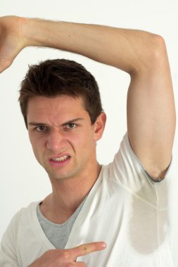 Man sweating very badly under armpit and pointing there clipart