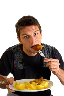 Young man eating a Schnitzel and potatoes clipart