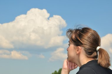 Head in sky - dreaming young woman clipart