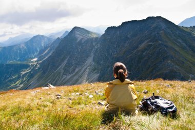 Young woman in mountains - relax scene clipart