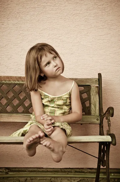 Portret dziecka - usytuowanie na ławce — Zdjęcie stockowe