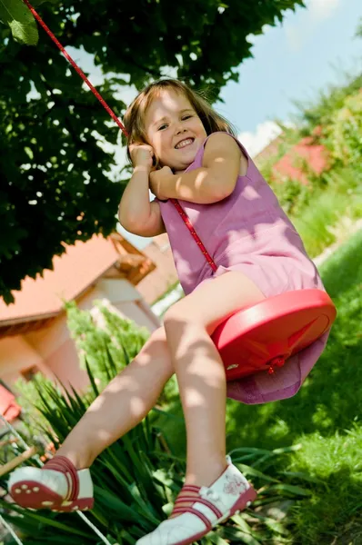 Girl swinging on seesaw — Stock Photo, Image