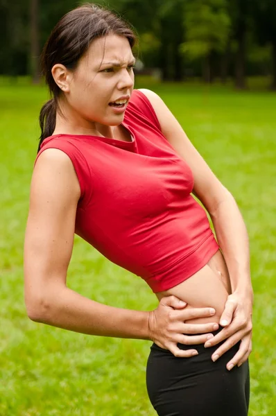 Buttocks injury - sportswoman in pain — Stock Photo, Image