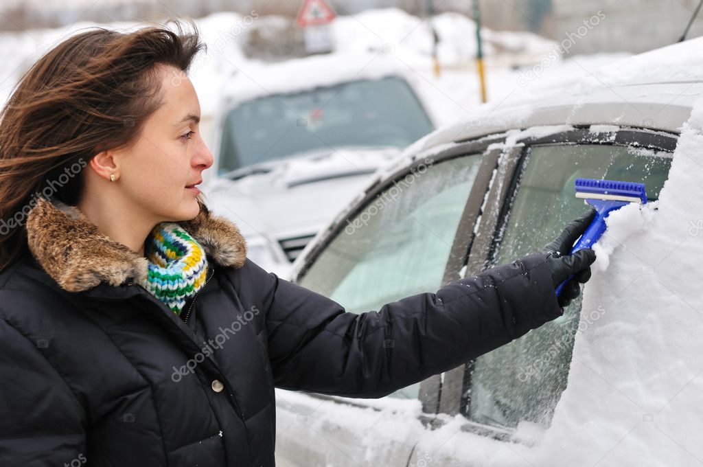 Winter time - person cleaning car