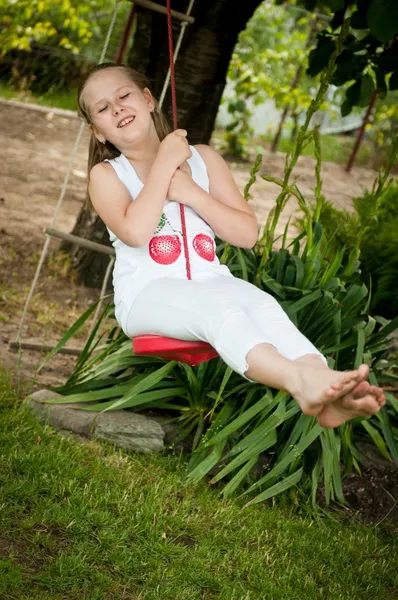 Child swinging on seesaw — Stock Photo, Image