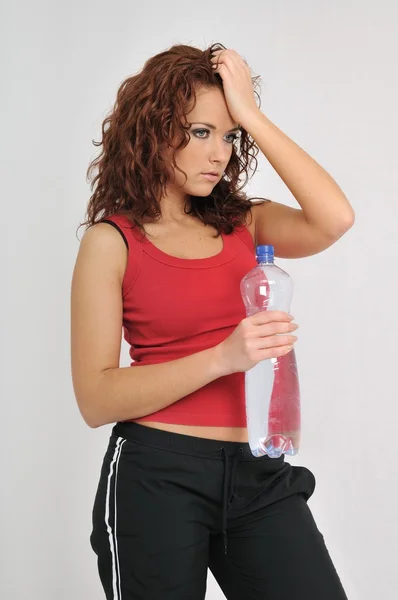 Tired fitness woman with bottle of water — Stock Photo, Image