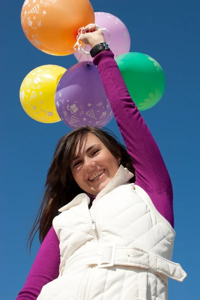 Happy girl holding balloons — Stock Photo, Image