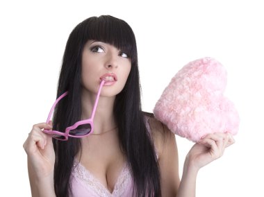 Beautiful woman in pink glasses with plush heart