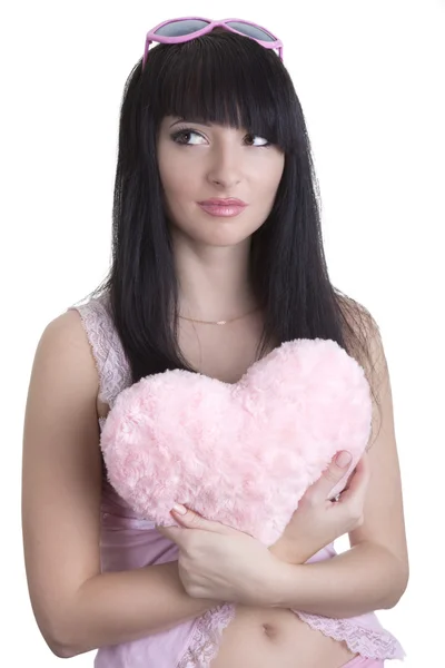 Beautiful woman in pink glasses with plush heart — Stock Photo, Image