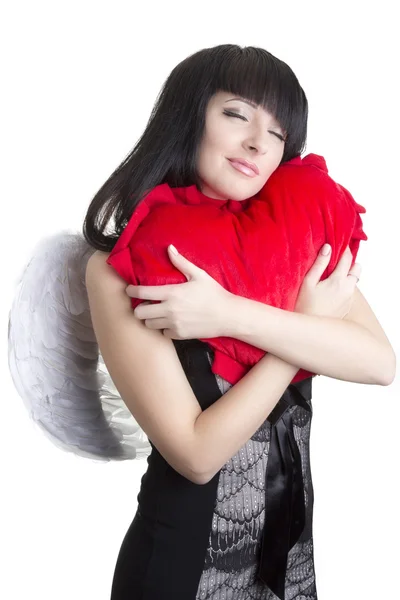 Mulher anjo bonito abraçando coração vermelho — Fotografia de Stock
