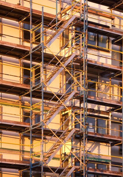 Scaffolding on a block of flats in evening sunlight