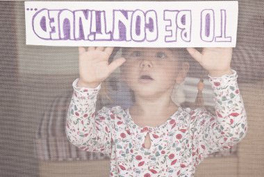 Child holds a sign 