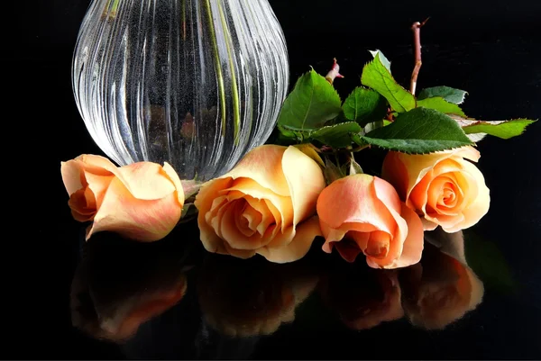 Rosas e cera de vidro na mesa preta — Fotografia de Stock