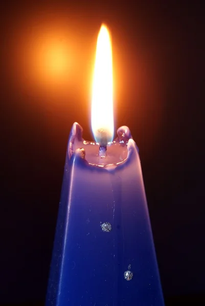 Burning blue candle during christmastime — Stock Photo, Image