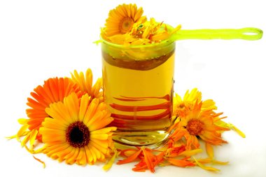 Marigold petals and herbal tea as natural medicine clipart