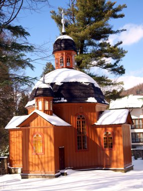 Small wooden catholic chapel in Krynica clipart