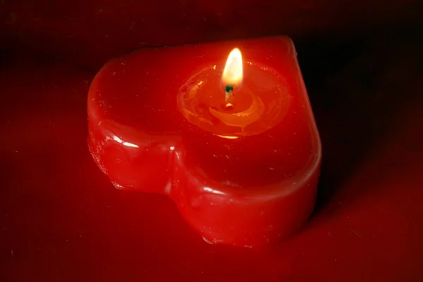Burning red candle as a symbol of hot love — Stock Photo, Image