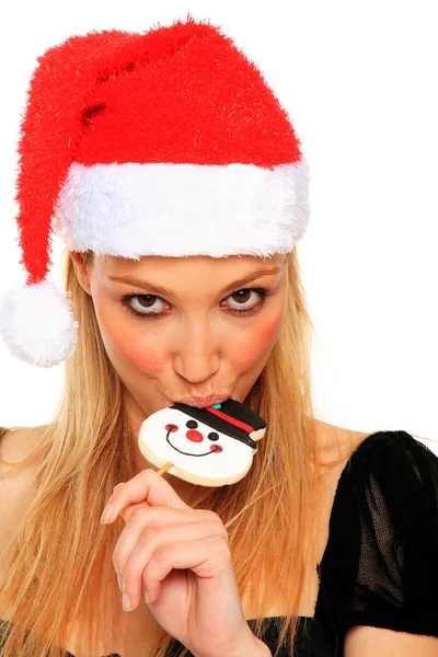 Sexy christmas girl bites a candy — Stock Photo, Image